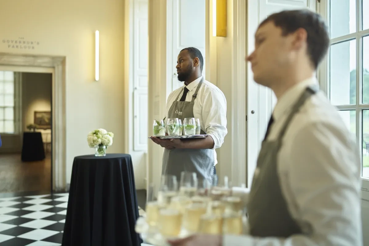 The Clink Staff welcoming guests in the orangery with champagne trays