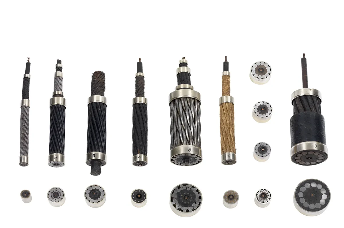 A set of submarine cable samples of varying lengths and designs, laid out against a white background