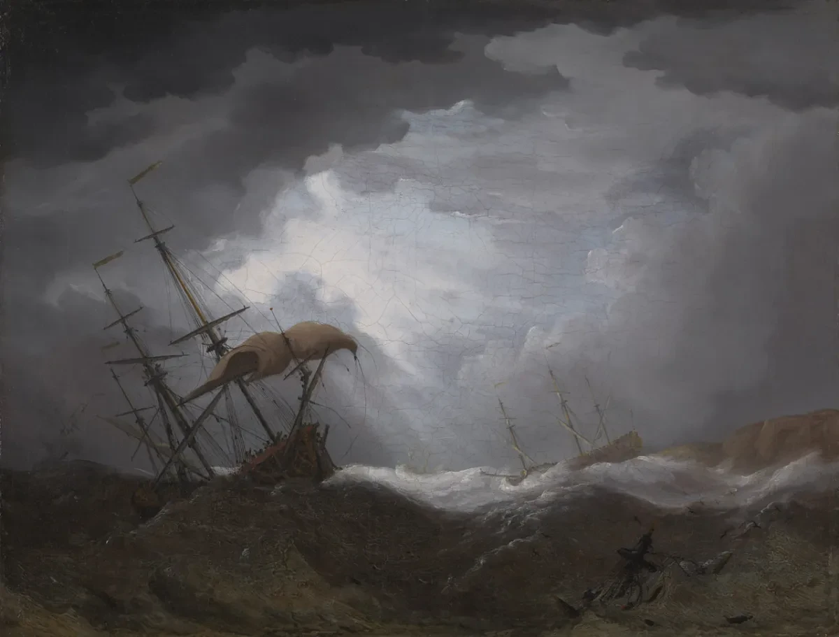 Oil painting showing sailing ships in distress during a storm. A ship on the right is perilously close to rocks, while on the left a ship is straining against the wind. The atmosphere is dark and brooding, but light is beginning to cut through the clouds in the background