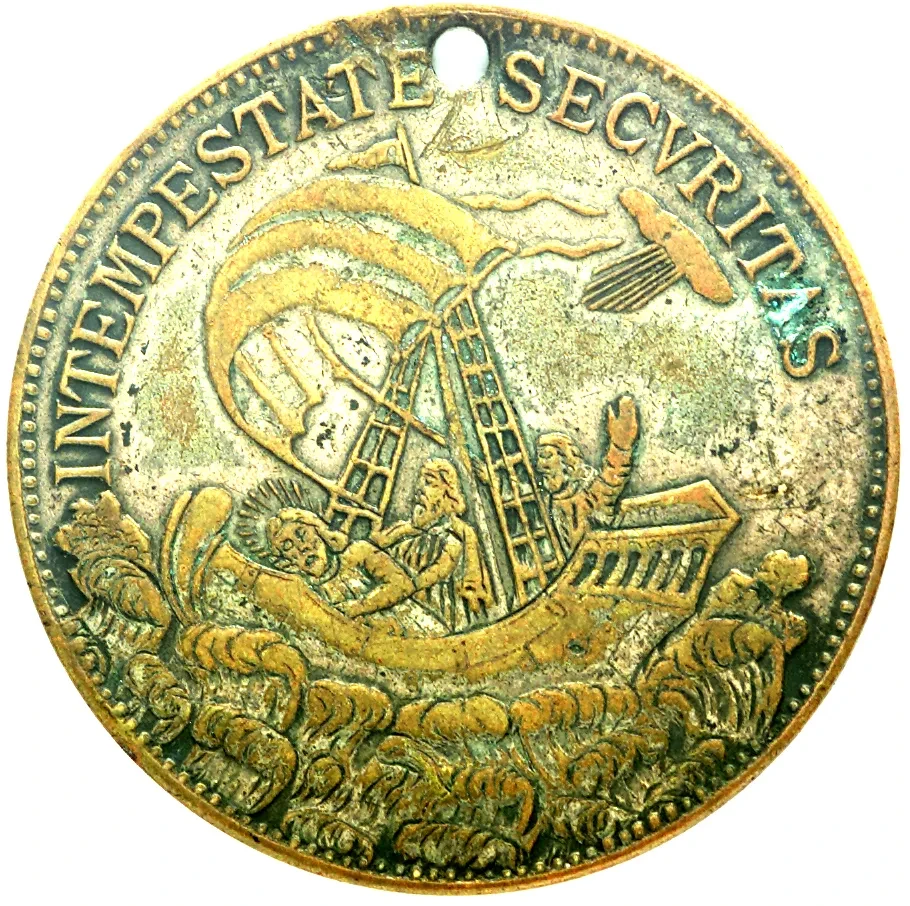 An old coin against a white background. The coin features a design showing a fishing boat amid the waves, with the words 'IN TEMPESTATE SECURITAS' around the edges