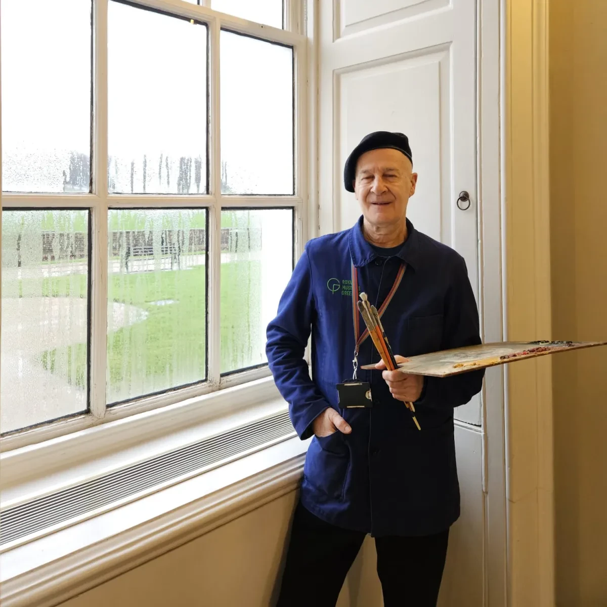 Artist Federico Baeza Autillo stands in front of a large window in the Queen's House