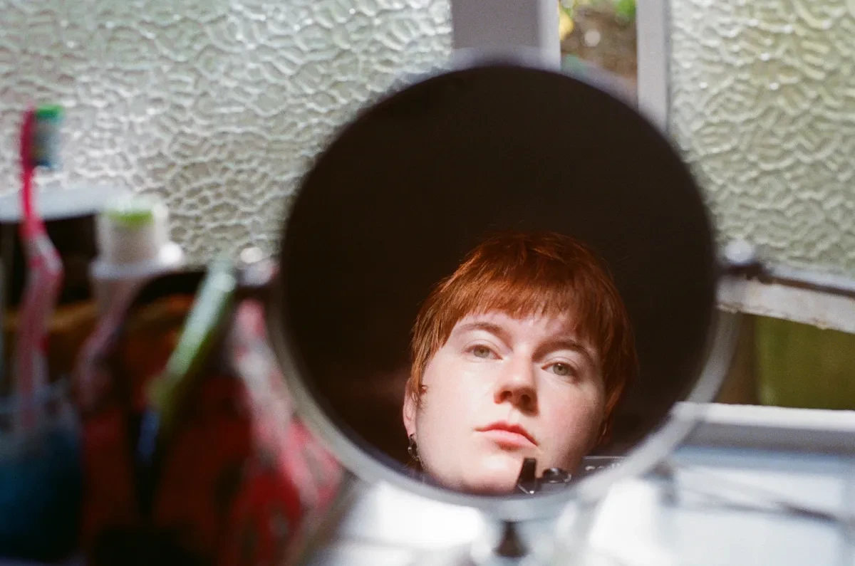 Close up of illustrator Linnea Maertens looking into a mirror