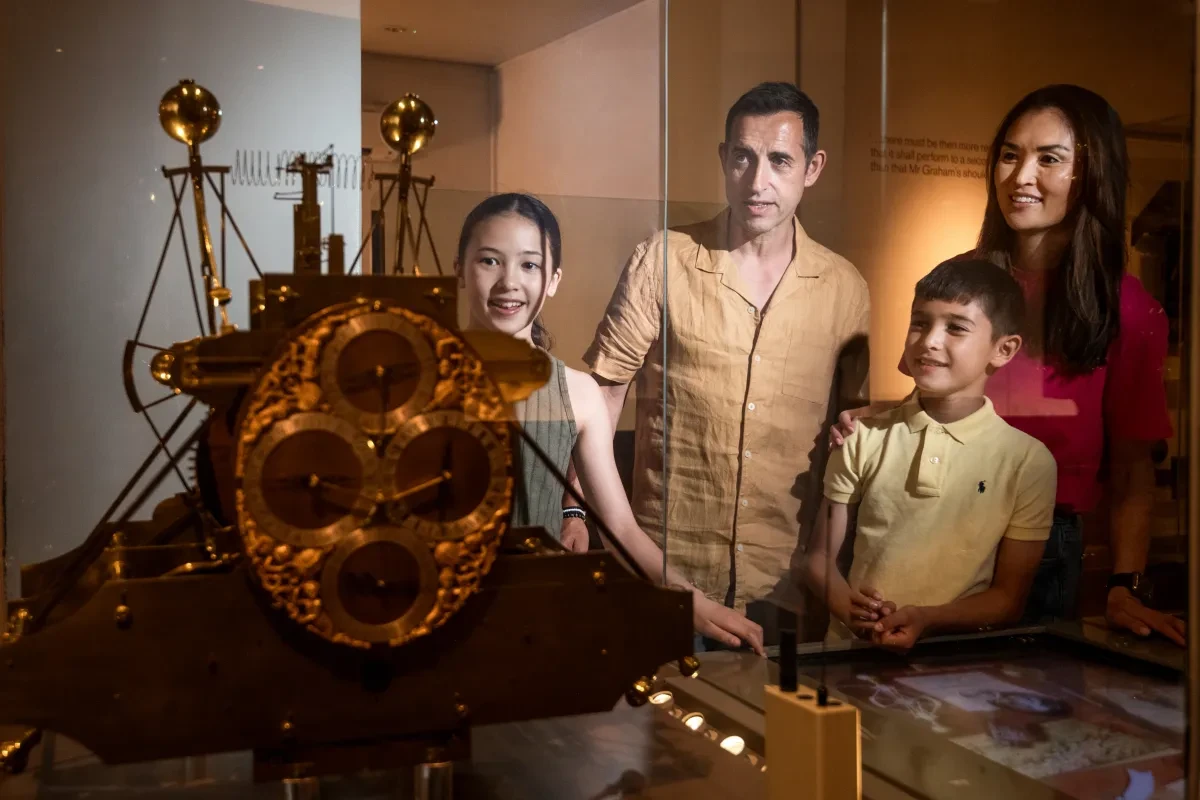 A family of four looking at the Harrison clocks in the Royal Observatory