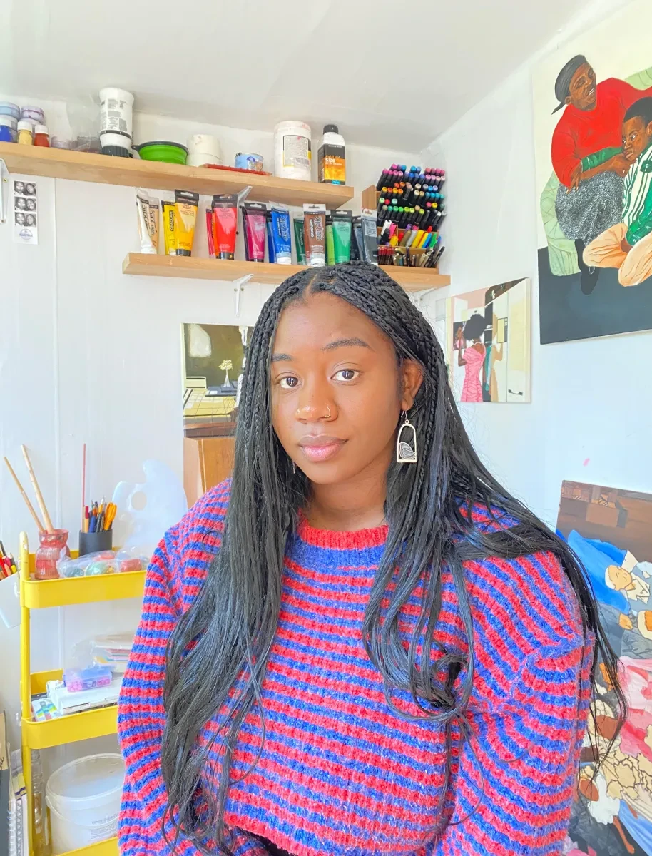 Headshot of artist Maïa Walcott in a colourful studio