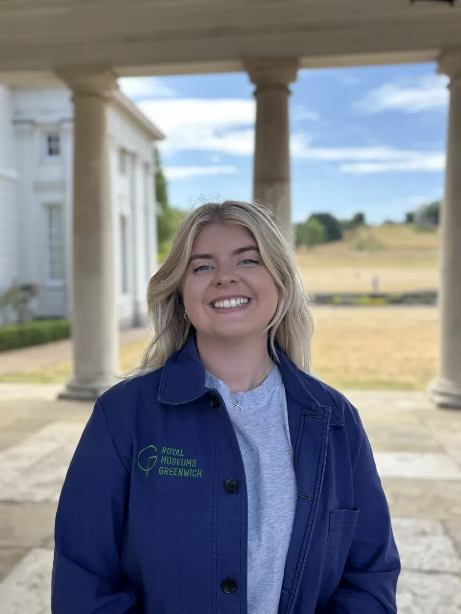 Headshot of curator Aimee Mook wearing a dark blue Royal Museums Greenwich jacket