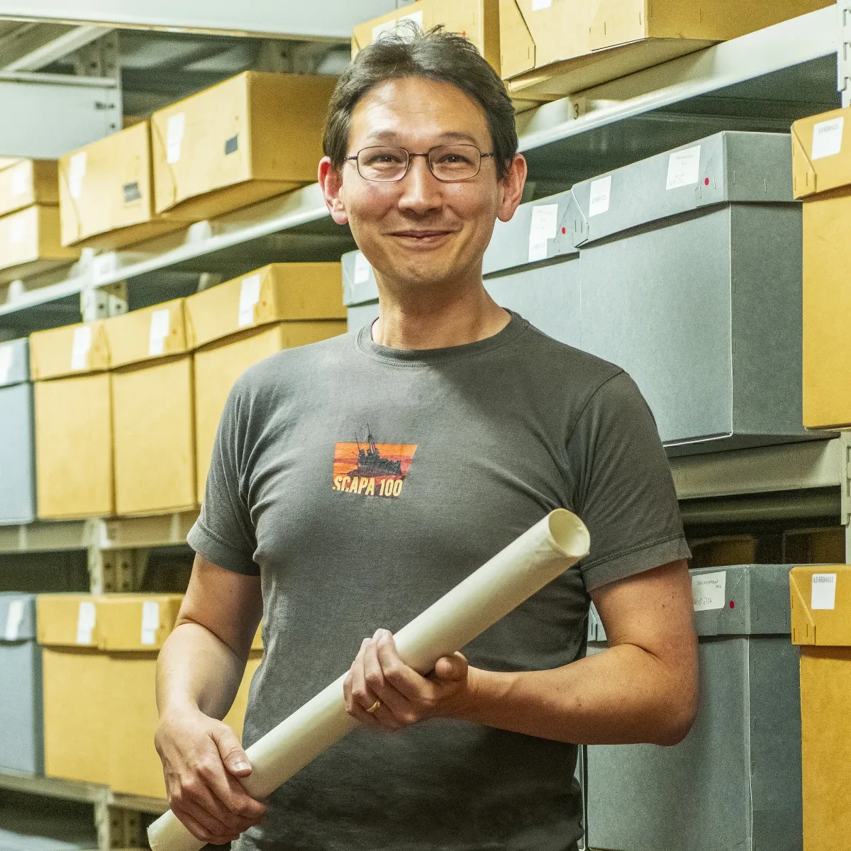 Curator Andrew Choong stands in the archives at Royal Museums Greenwich