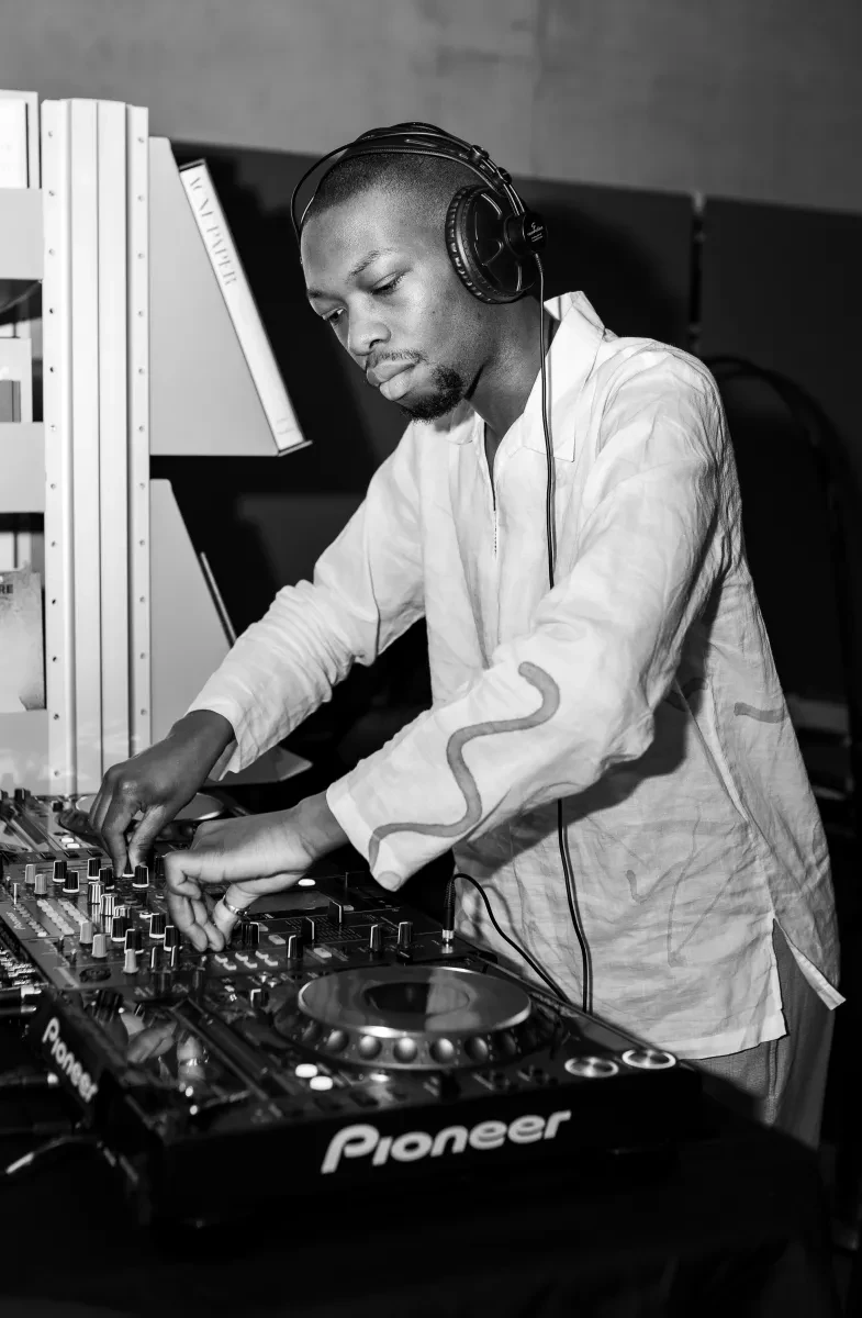Black and white photograph of Gabriel Dedji DJing