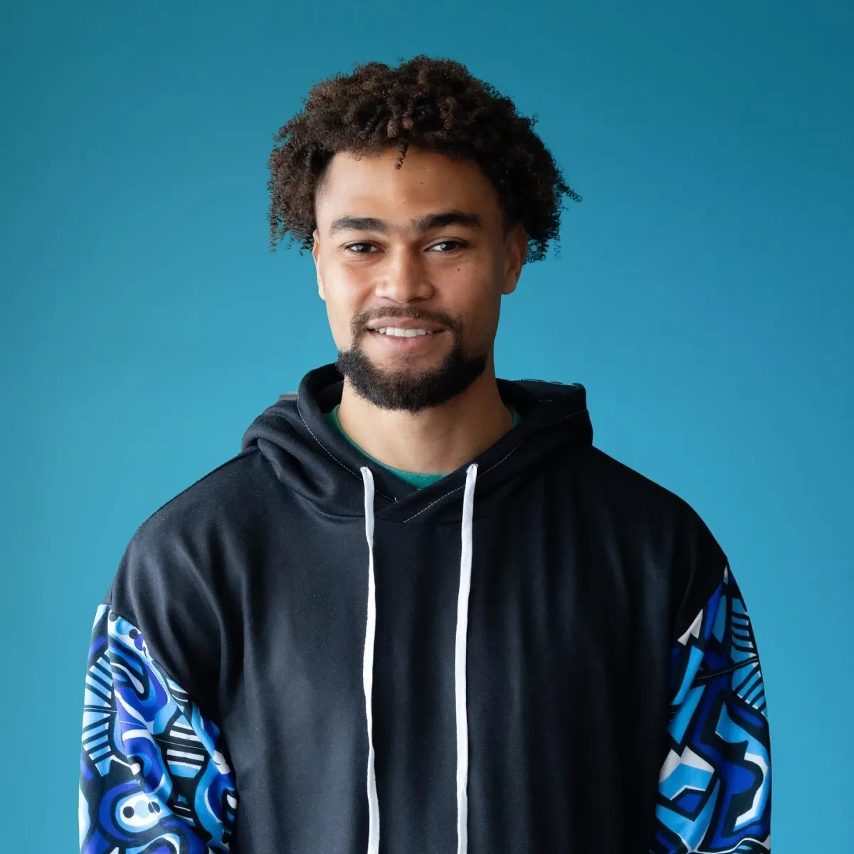 Headshot of Joel Sydenham wearing a hoodie