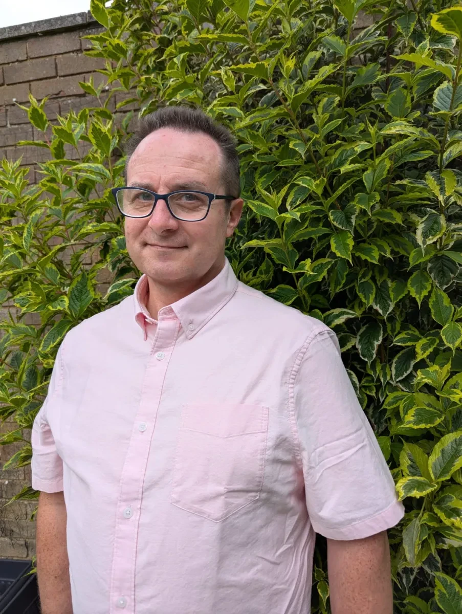 Headshot of Martin Salmon wearing a light pink shirt