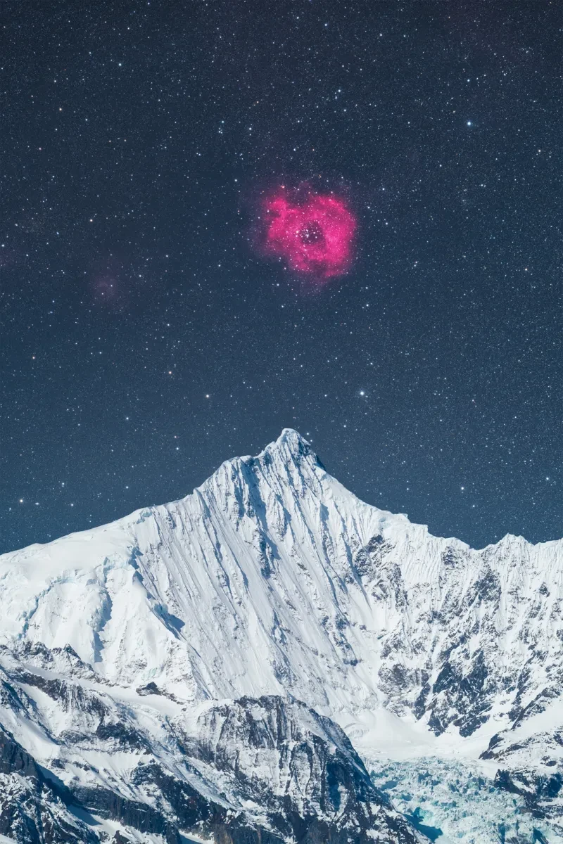 A bright pink rose-shaped nebula in a starry sky above a snowy mountain peak.
