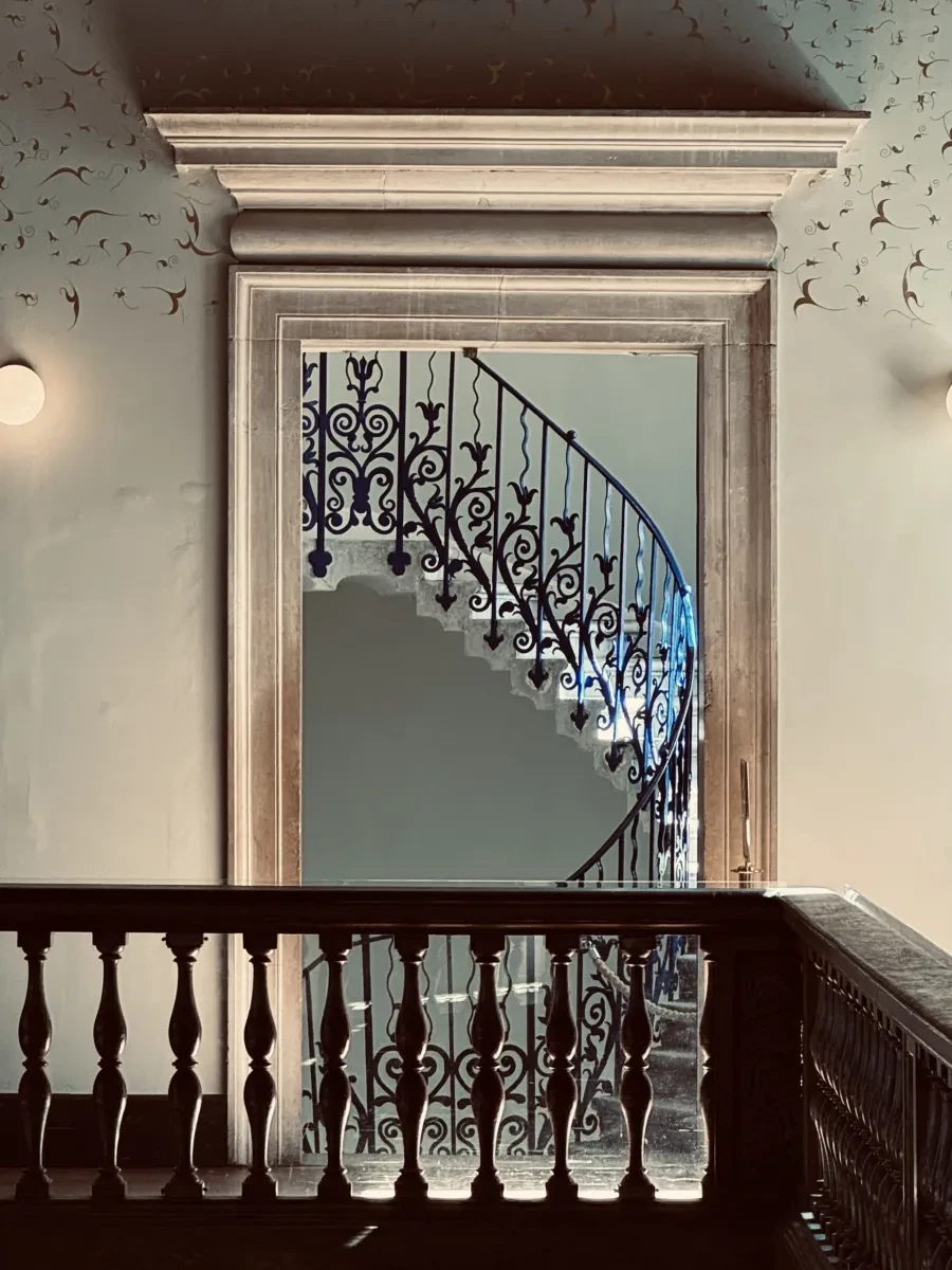 Great Hall balcony in the Queen's House at night with the Tulip Stairs shown in a doorway
