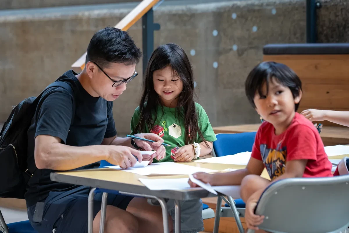 Family takes part in crafting activities at a table
