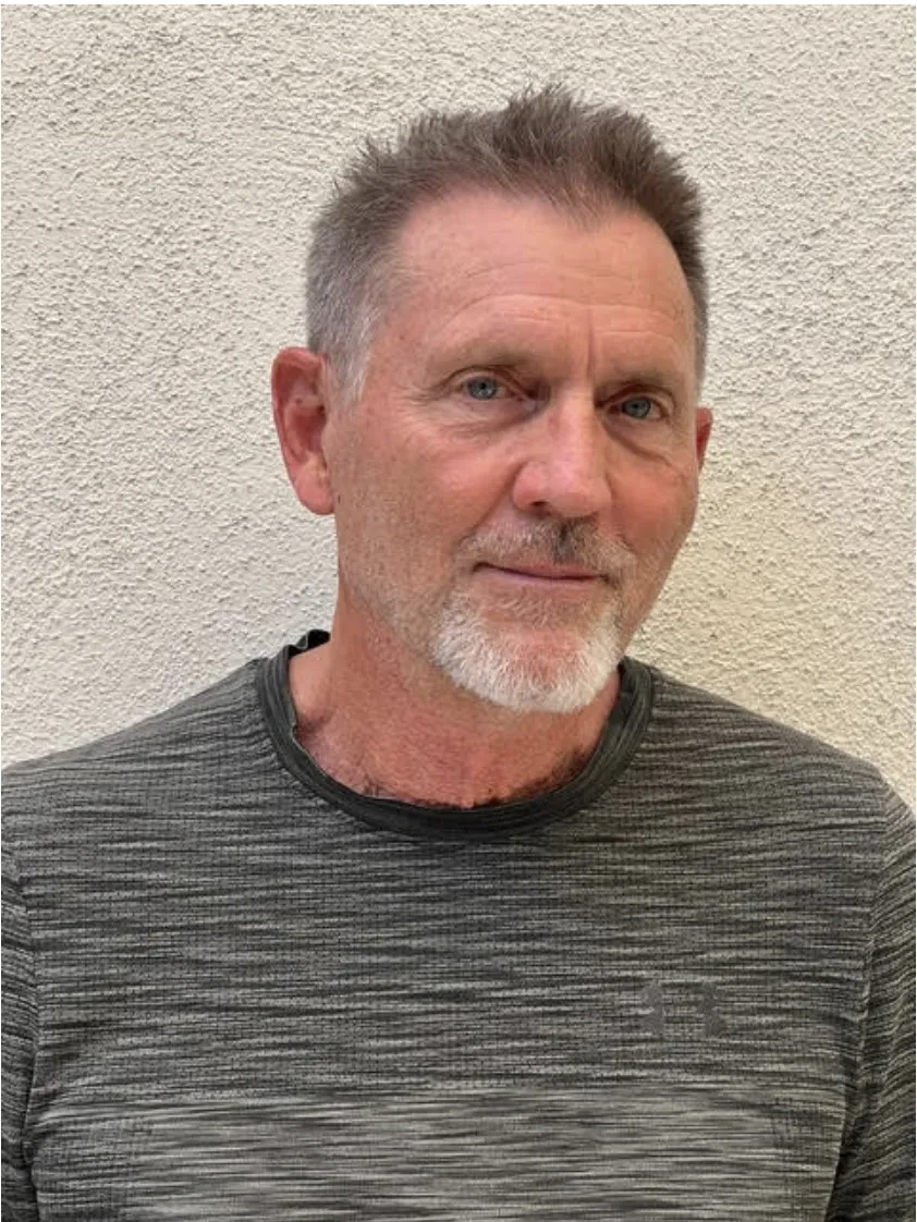 Headshot of a man wearing a grey t-shirt