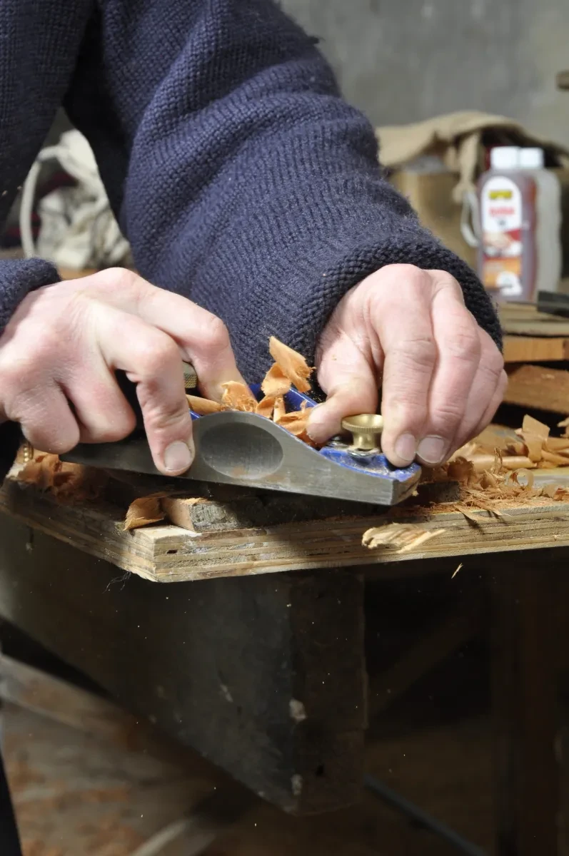 Close up detail of hands working with traditional tools