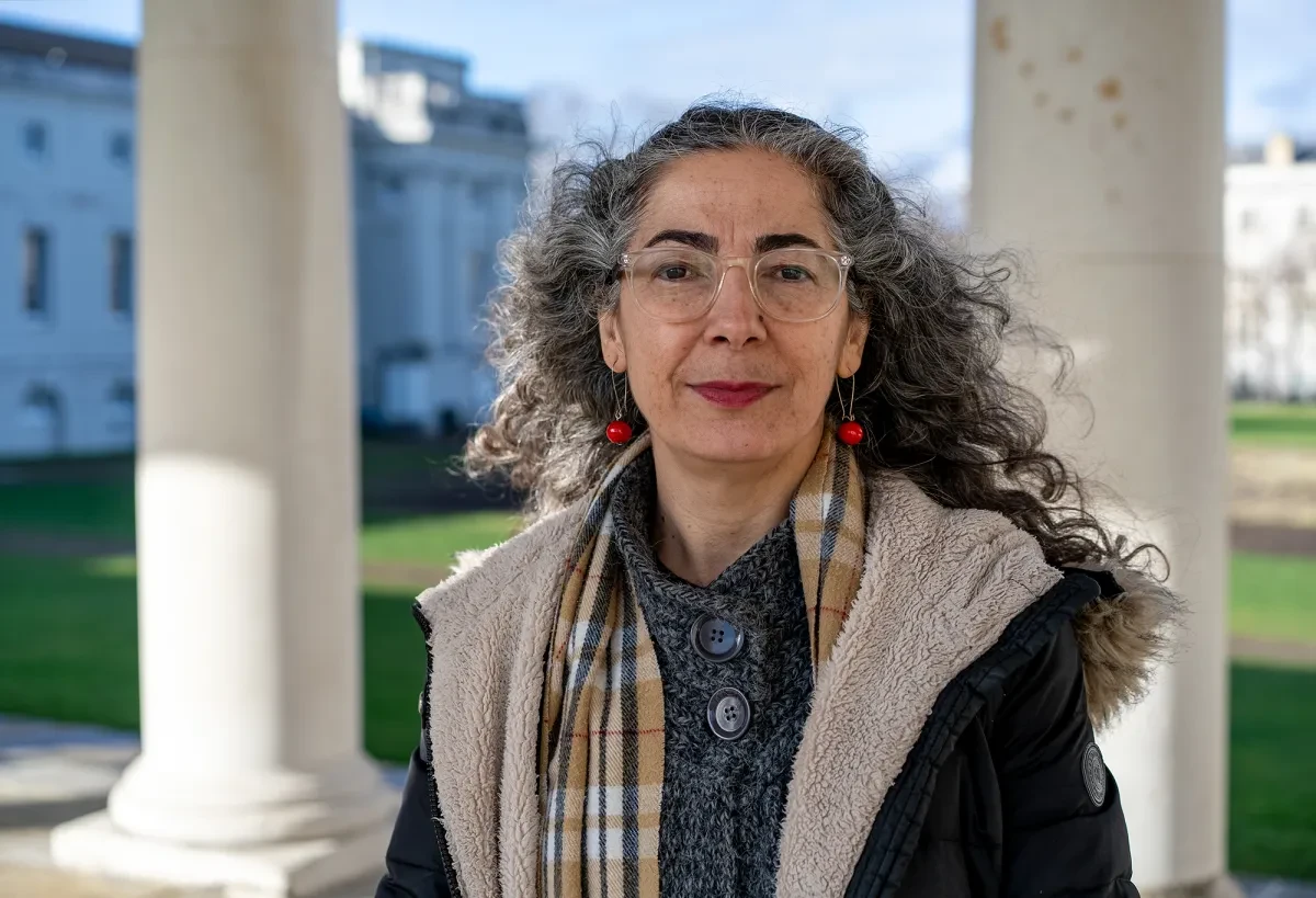 Artist Güler Ates standing in the colonnades outside the Queen's House
