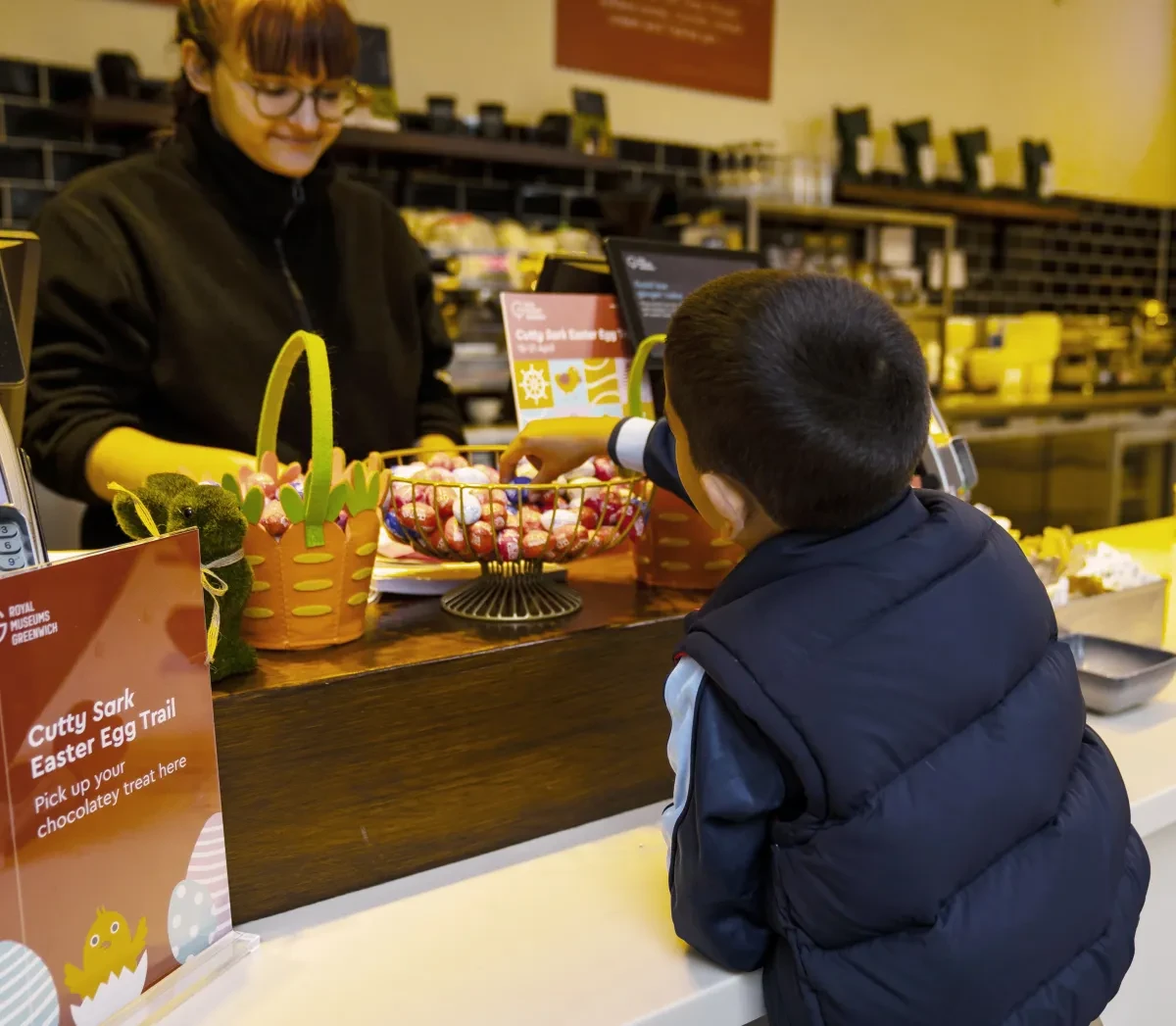 Child collecting chocolate egg as part of the Cutty Sark Easter Egg Trail