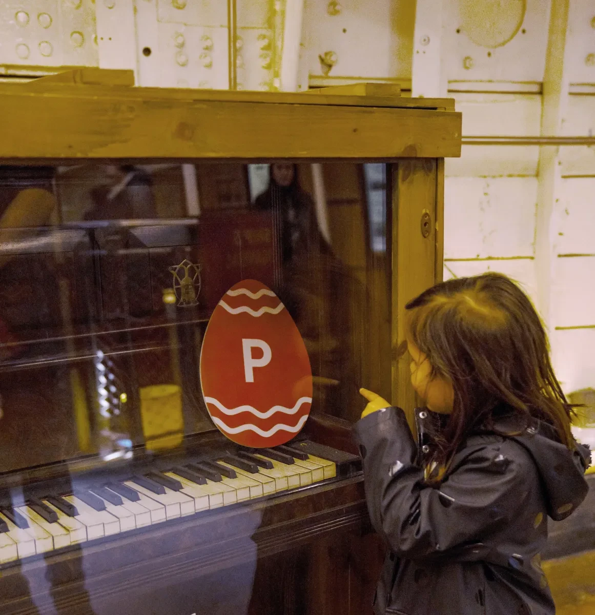 Child pointing at egg with letter on as part of the Cutty Sark Easter Egg Trail