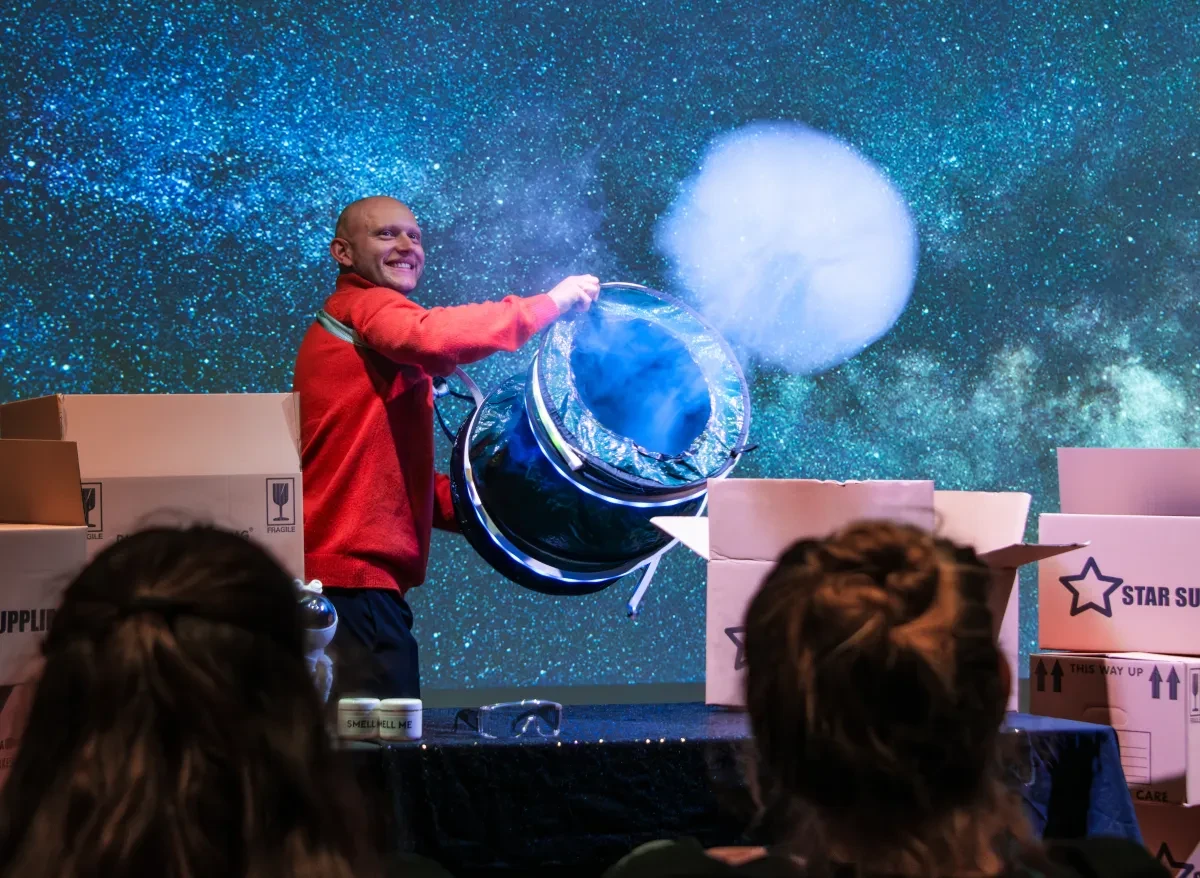 Photo showing a person on stage creating a smoke ring.