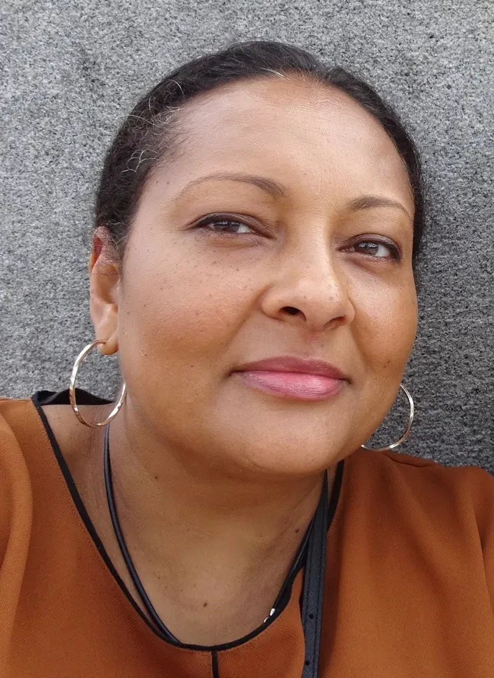 Headshot of Dr Juanita Cox wearing an orange top