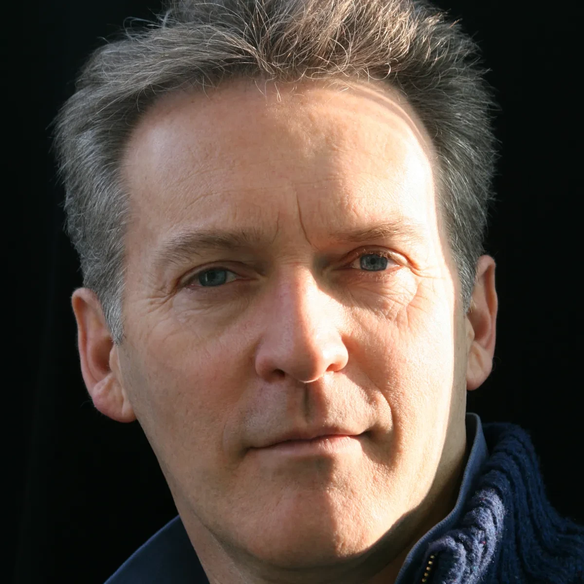 Author Robert Seatter. He has light grey hair and blue eyes, and is looking steadily at the camera