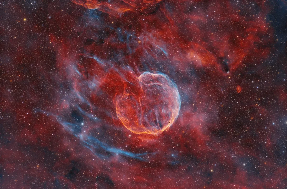 Close up of a spherical red supernova remnant