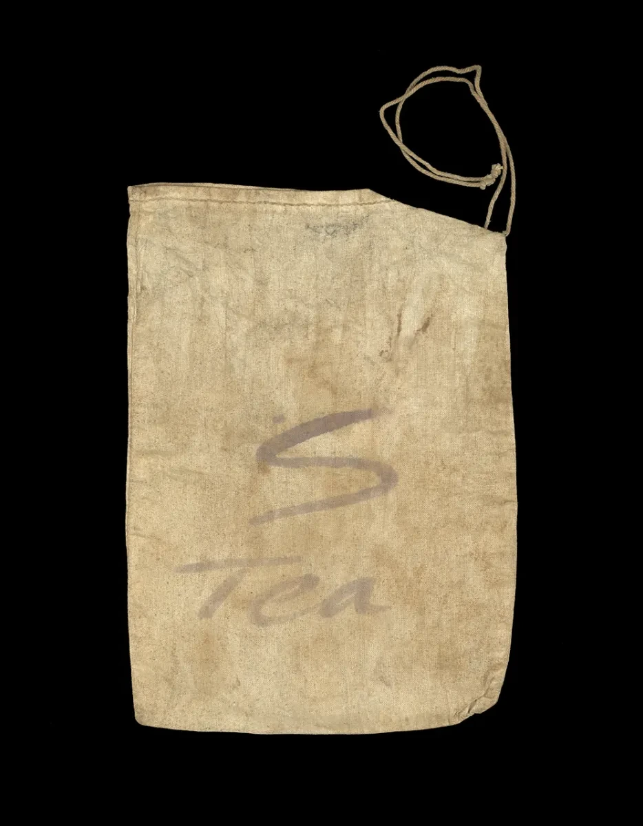 A linen summit ration bag with 'S' and 'Tea' written on it.