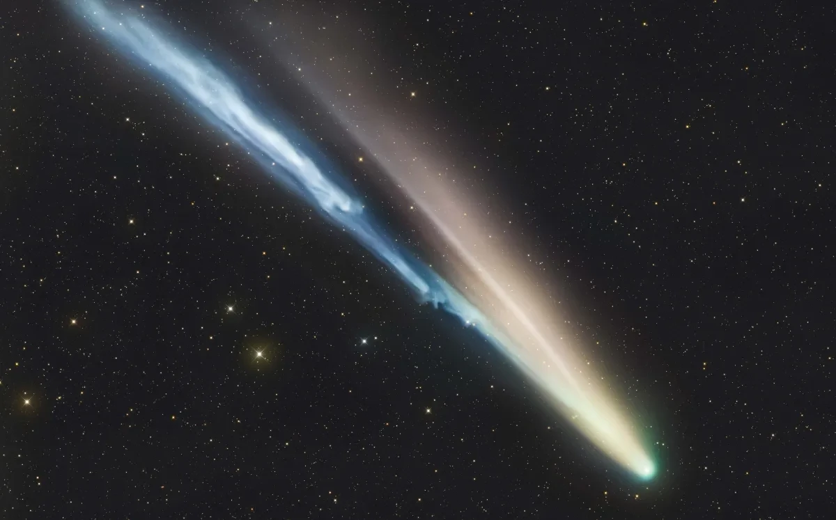Comet C/2026 A6 (Lemmon) streaking across the sky with a long dust tail against a backdrop of stars
