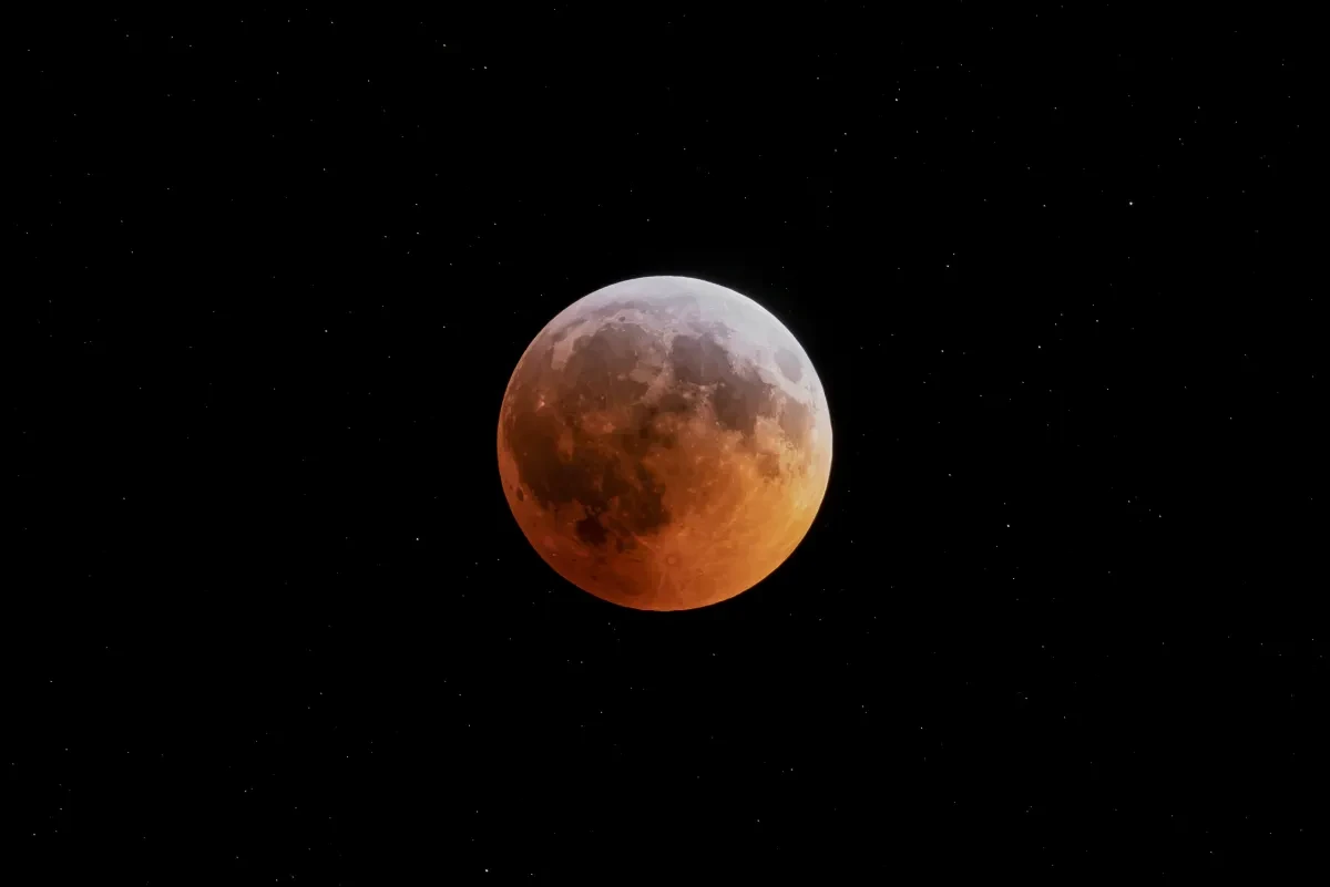 Photo of the Moon undergoing a lunar eclipse against black space 