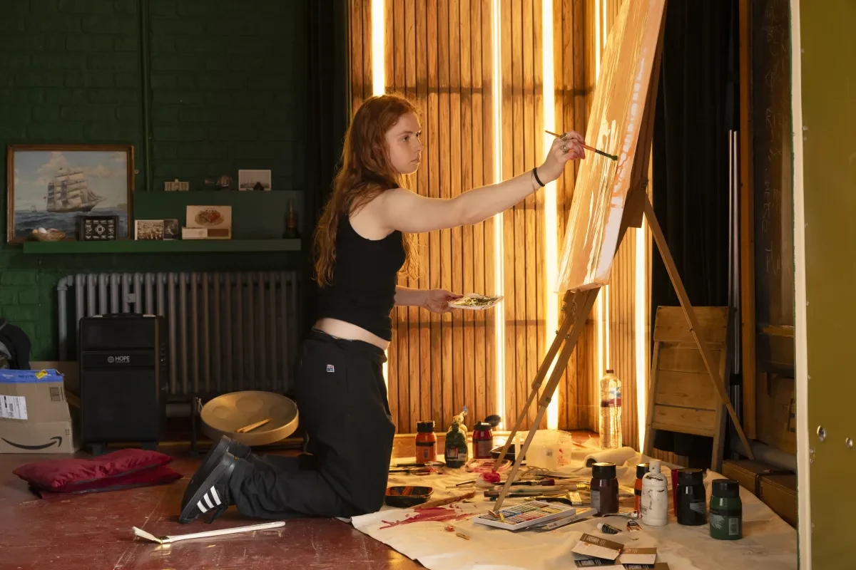 Girl knelling on the floor painting