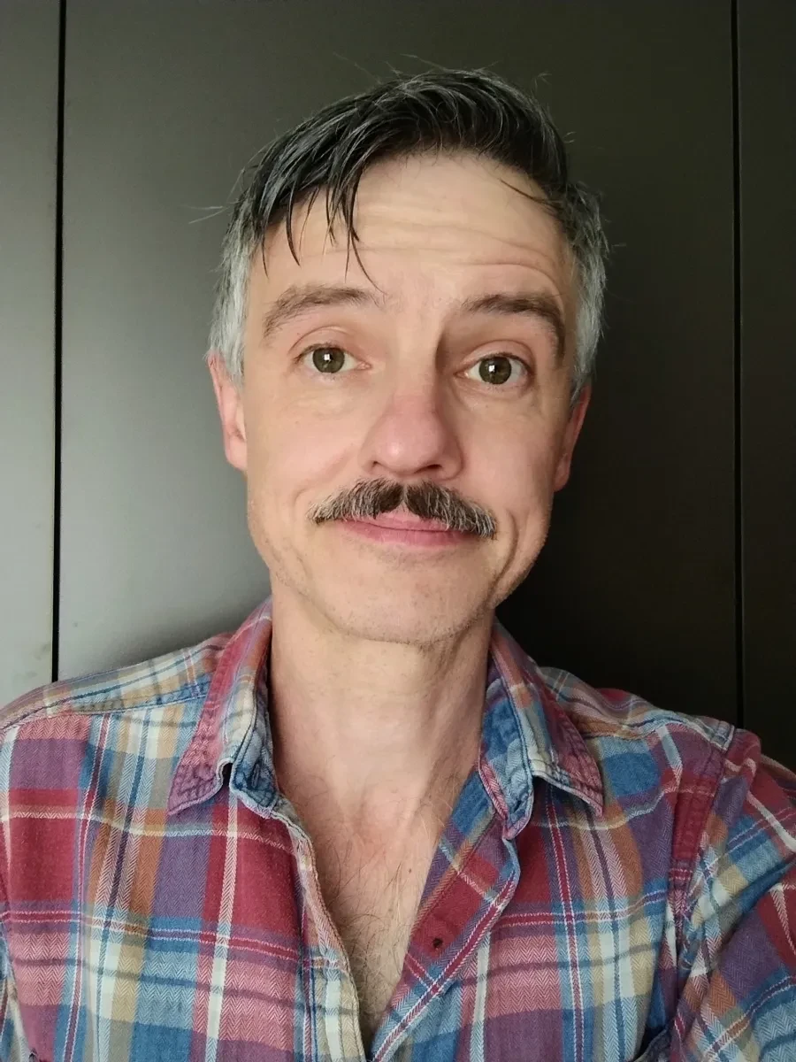 Headshot of man with moustache