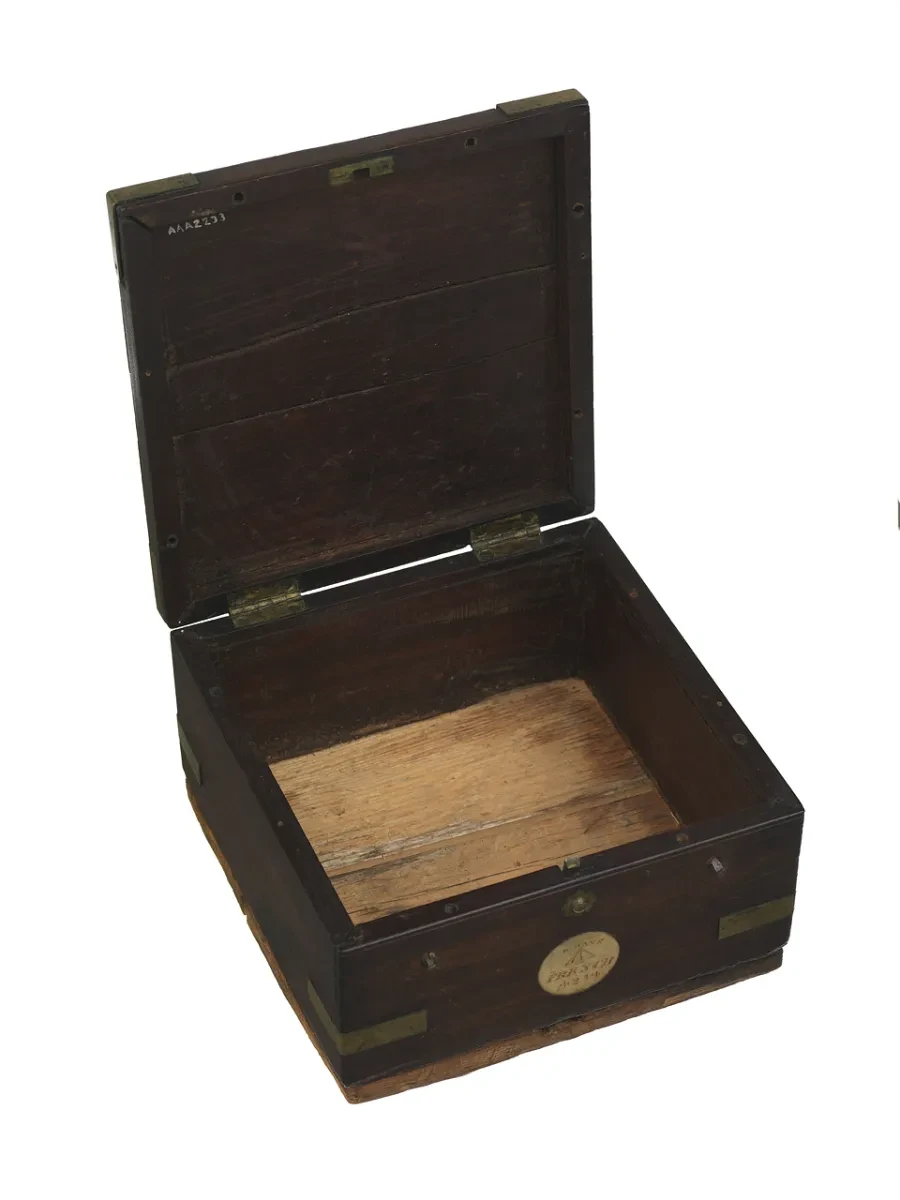 An empty wooden, brass-bound mahongany box that once held a chronometer called French 4214
