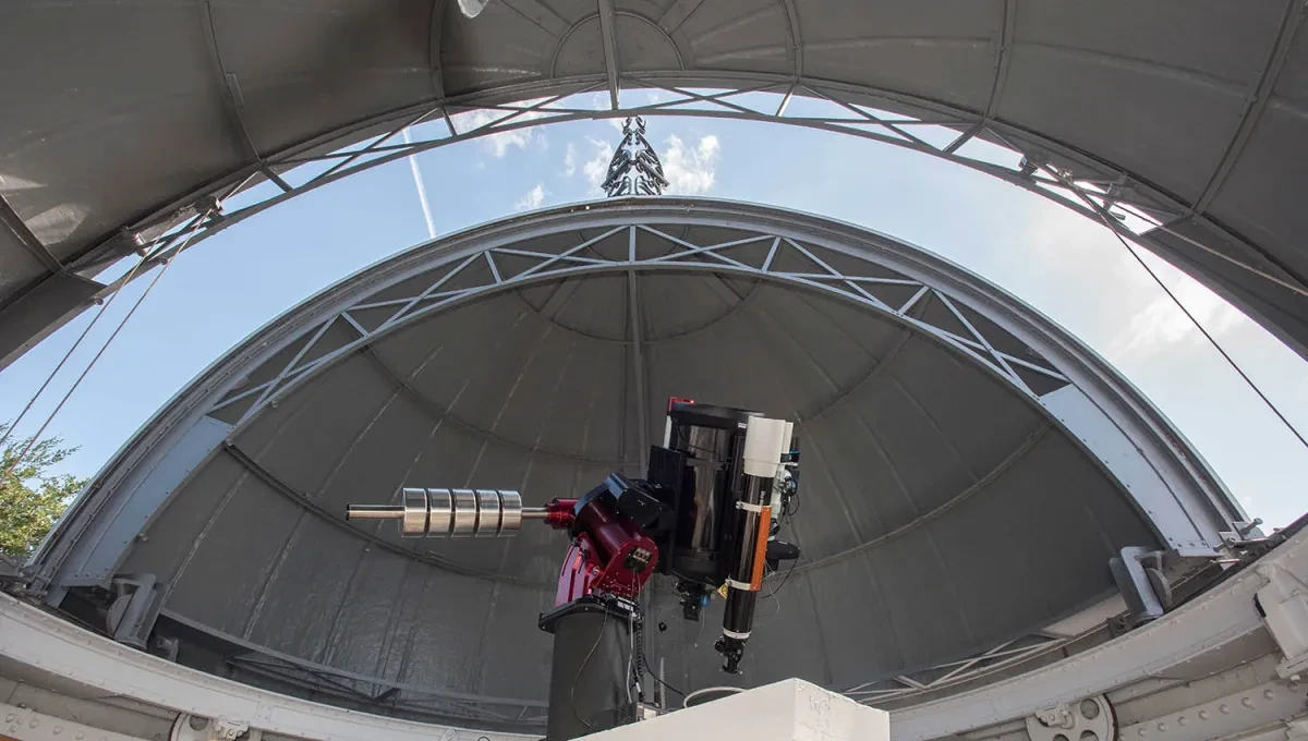 The telescope under a partially-opened domed roof.
