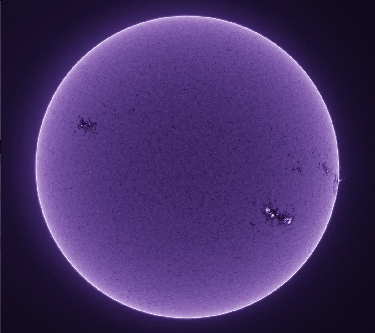 The Sun appears as a dark purple globe.