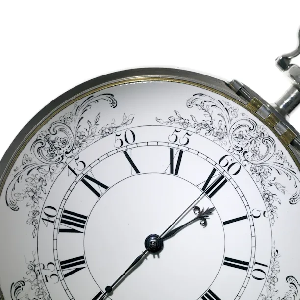 Detail of the black and white face of a Harrison timepiece.