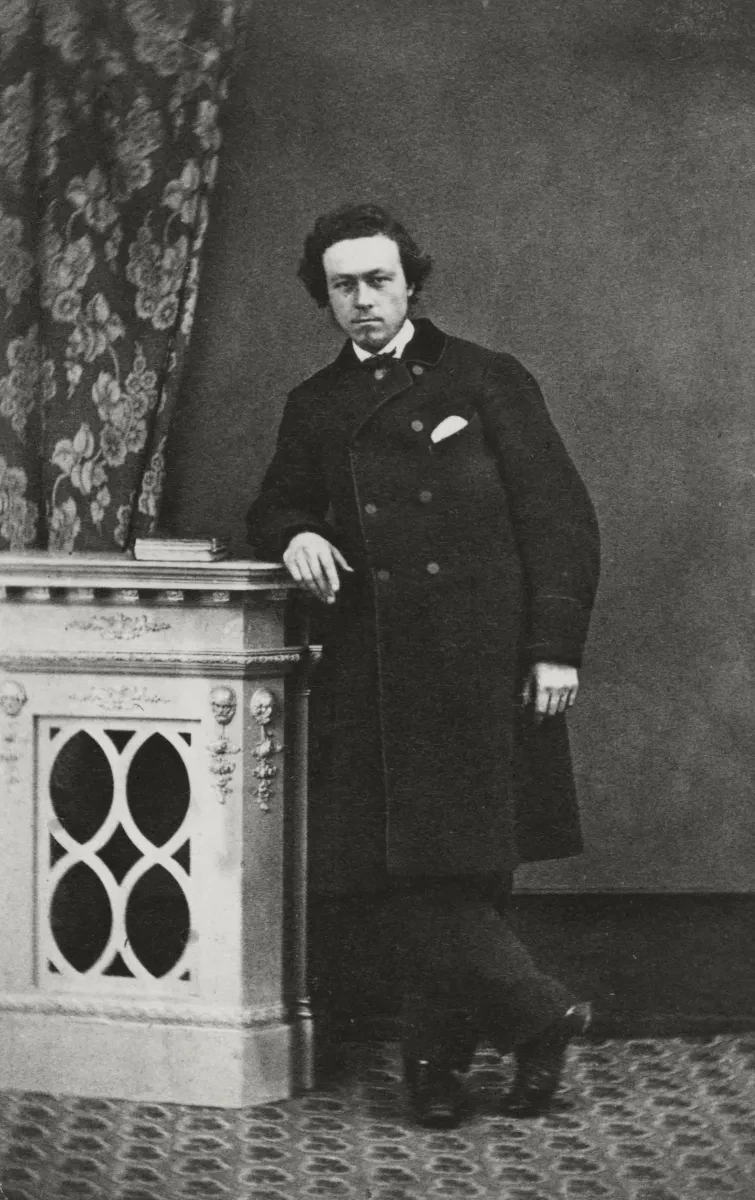 Black and white photograph of Hercules Linton. He has dark hair and wears a smart black suit and coat.