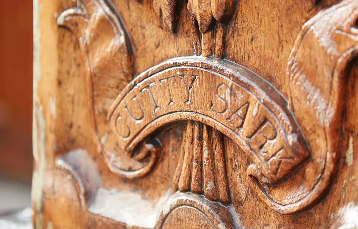 The name Cutty Sark on a carved wooden crest.