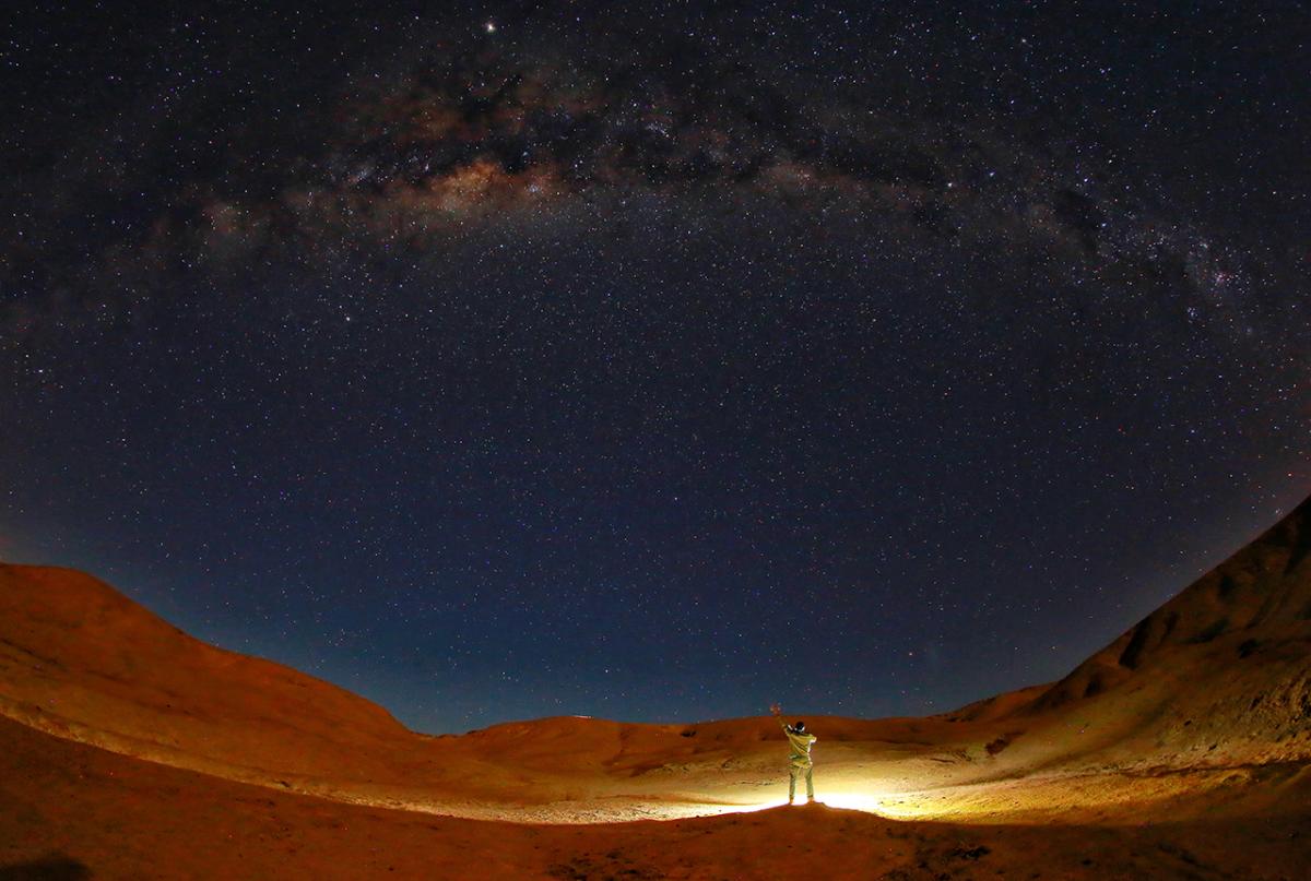 Person looking up at a wide sky