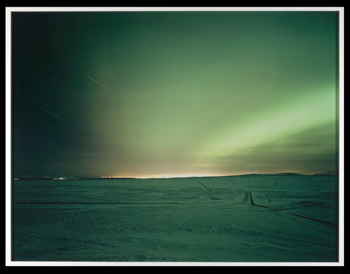 Sun beyond the horizon. The light show shades of green.