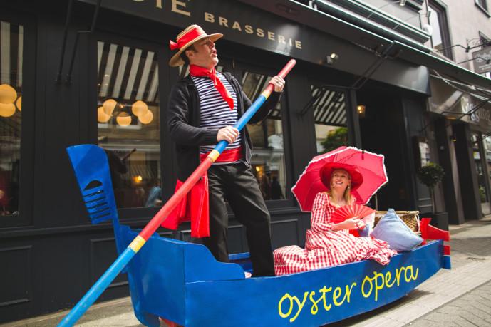 (Oyster Opera duo performing with venetian costumes and gondola picture)