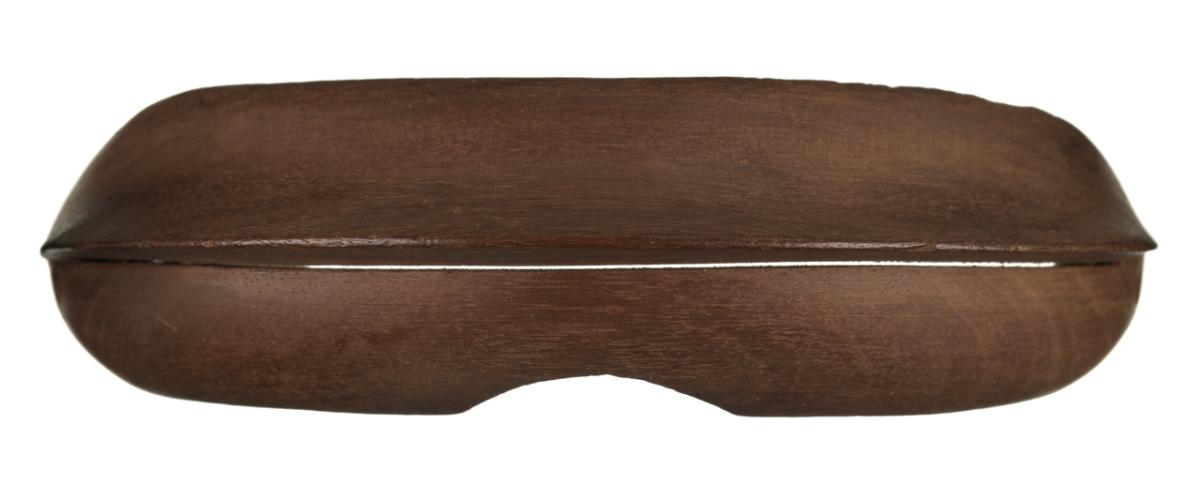 A curved wooden shield designed to fit over the eyes, with a narrow slit in the centre to see through