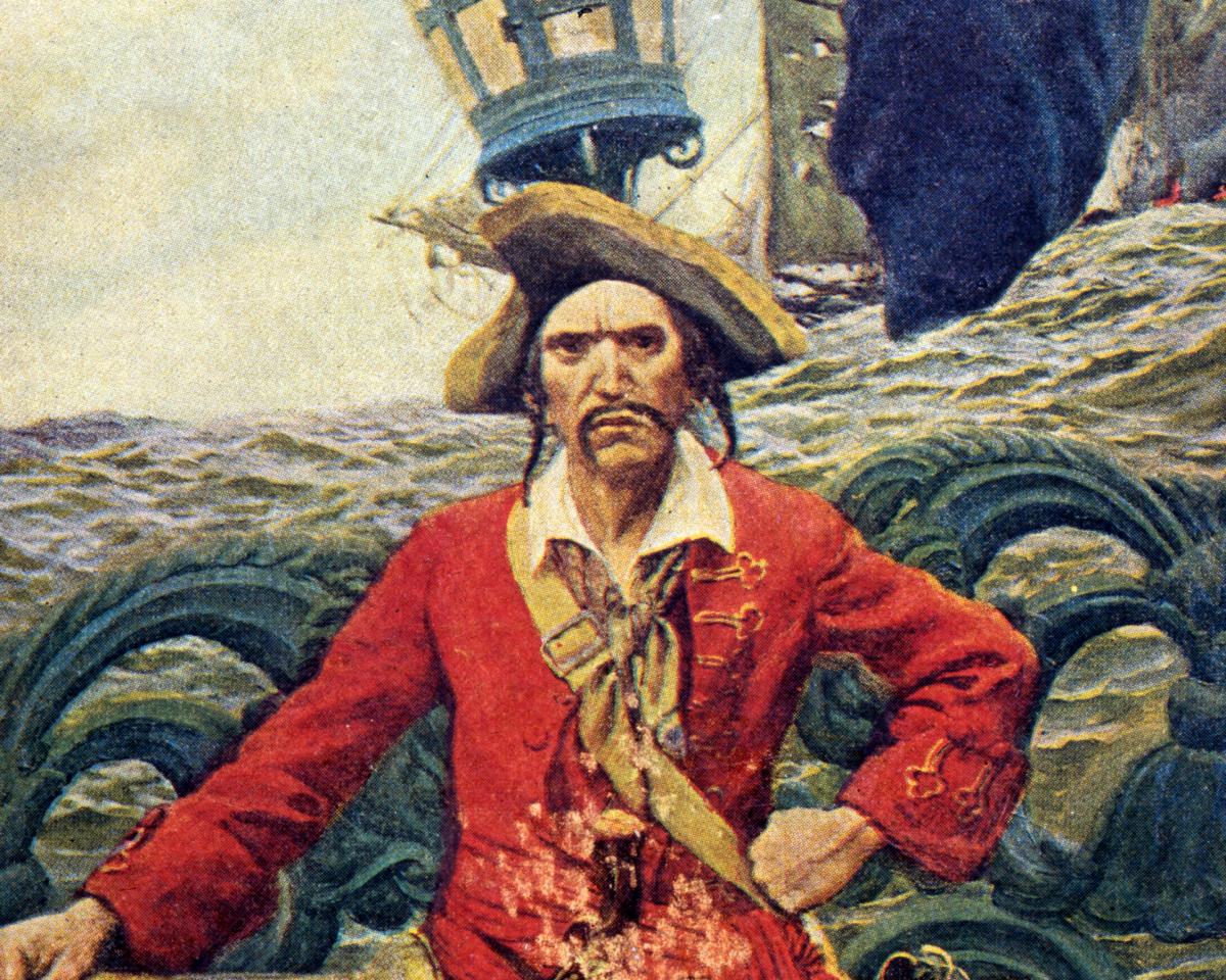 An illustration of a pirate, dressed in a red coat and a tricorn hat. He is scowling, with a rough sea visible in the background