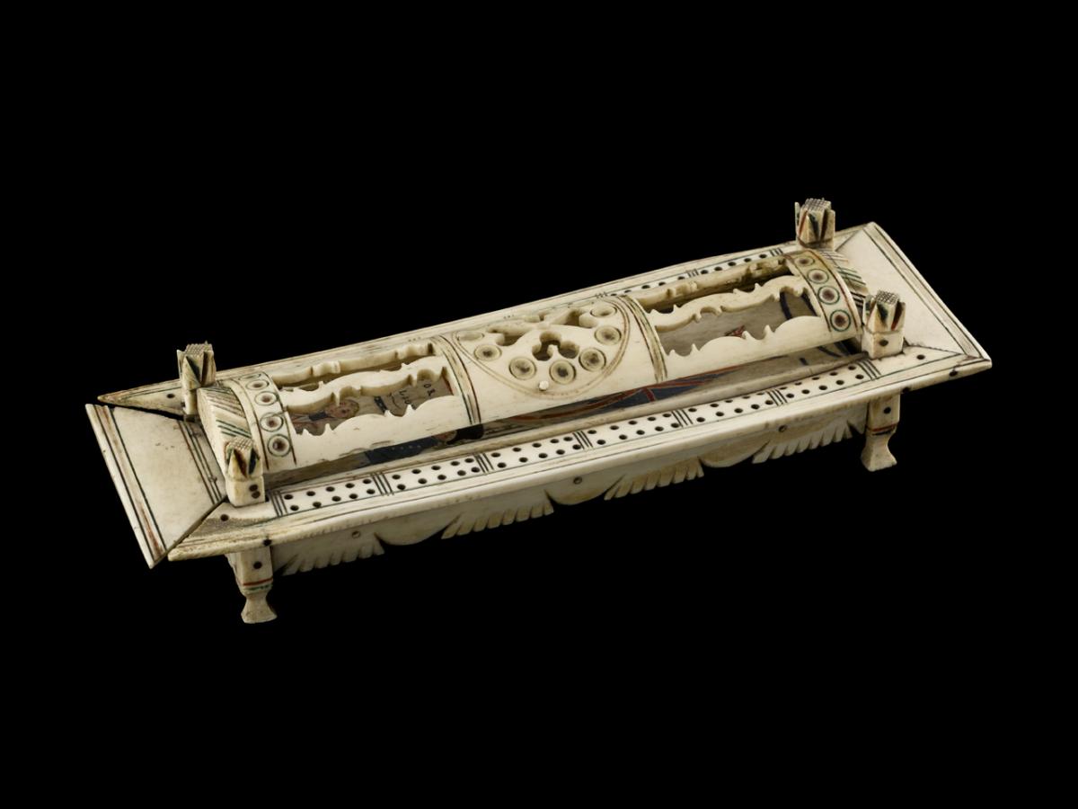Photo of rectangular carved bonework container with dominos inside