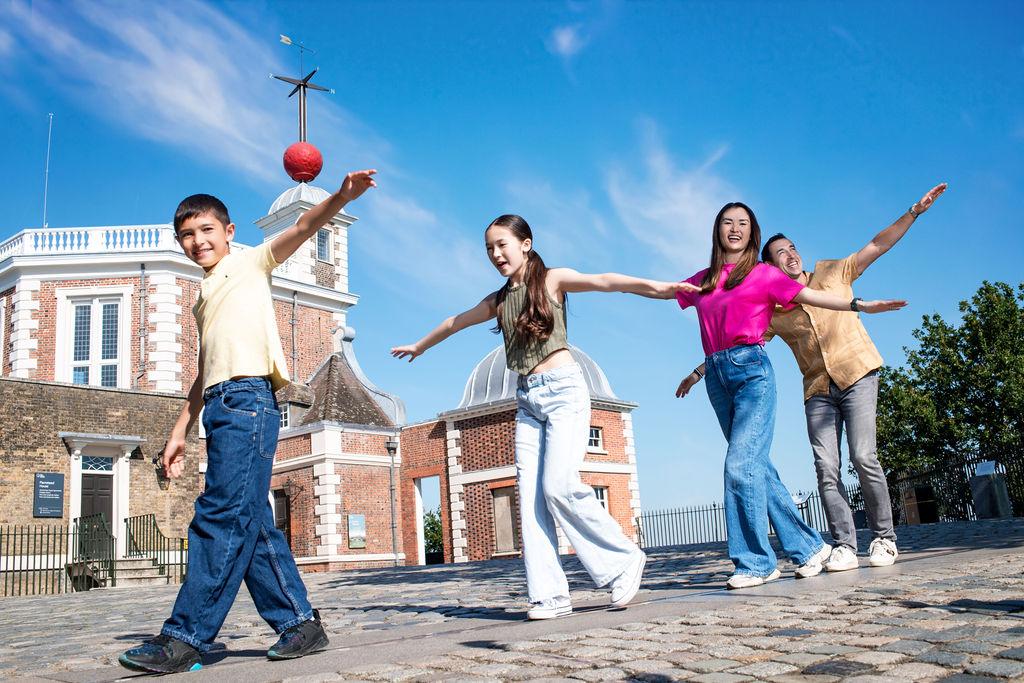 Family walking the Prime Meridian at the Royal Observatory
