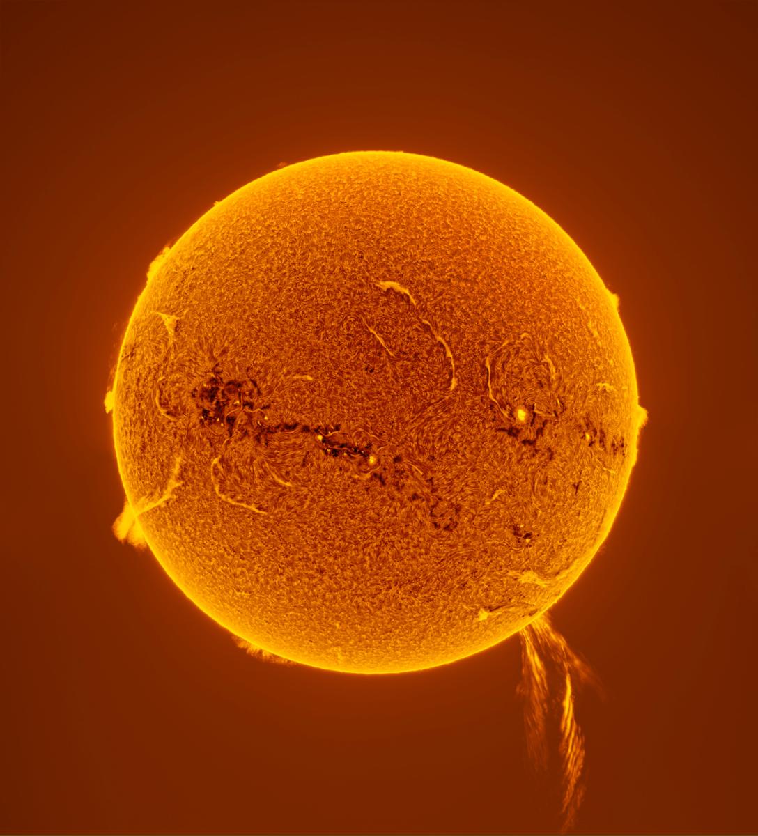 Photo of the Sun in bright oranges and yellows with a solar prominence coming out of the bottom of it