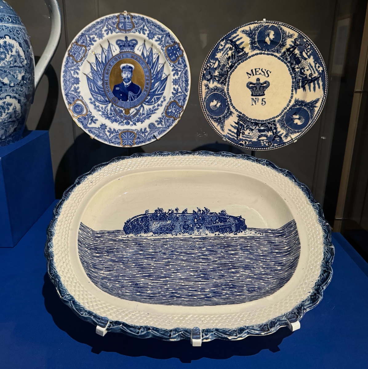 A blue and white dish with an image of a boat capsizing