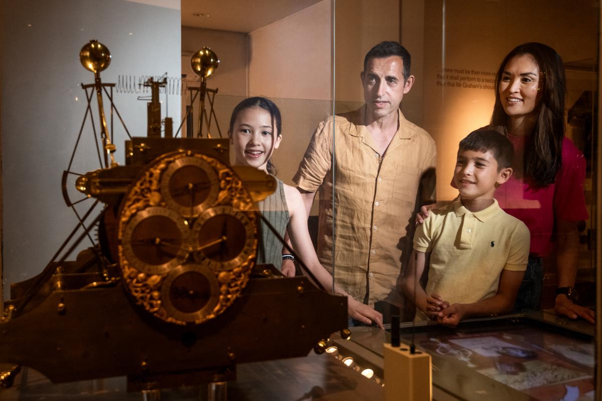 A family of four looking at the Harrison clocks in the Royal Observatory