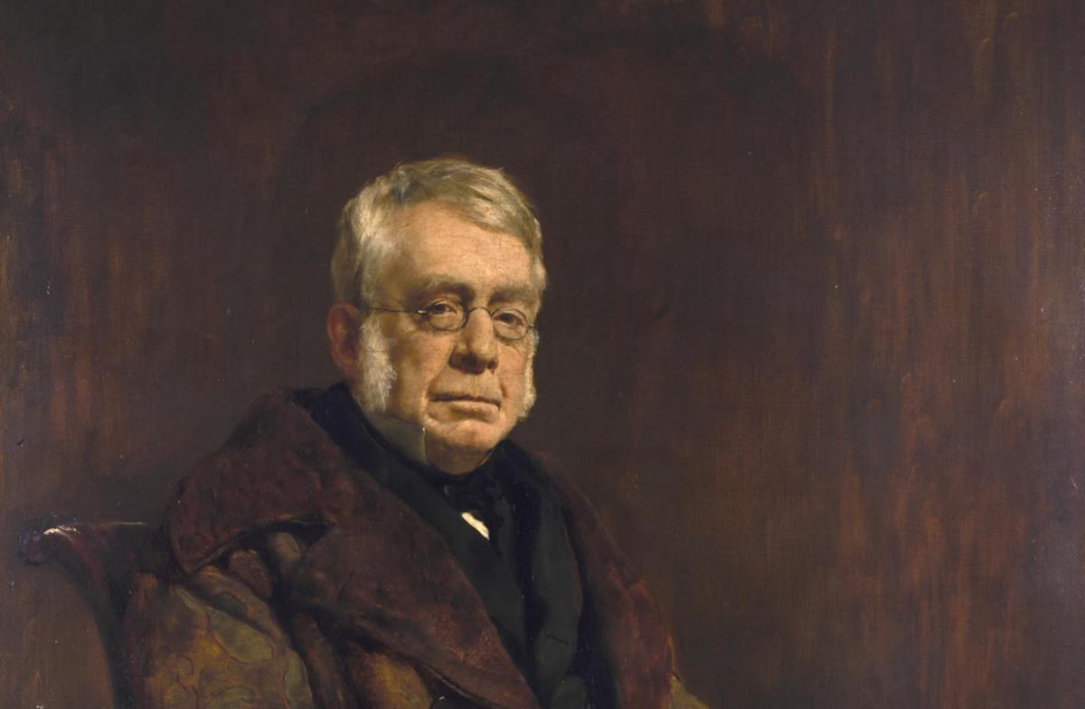Portrait of Sir George Biddell Airy with short hair, long sideburns and glasses.