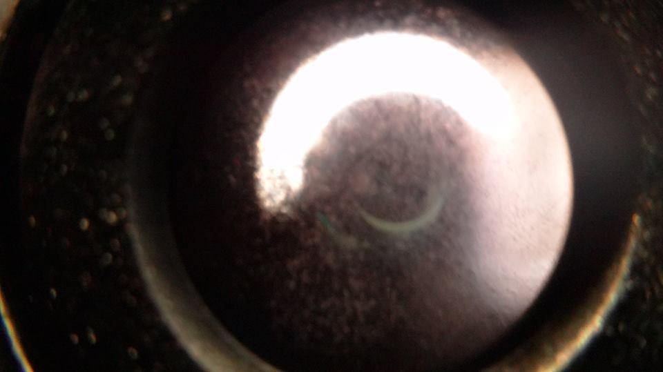The eclipse through my telescope. The bright crescent is the Sun 