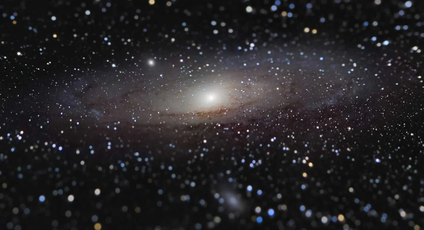 Photo of the Andromeda Galaxy - a dark black sky sprinkled with stars