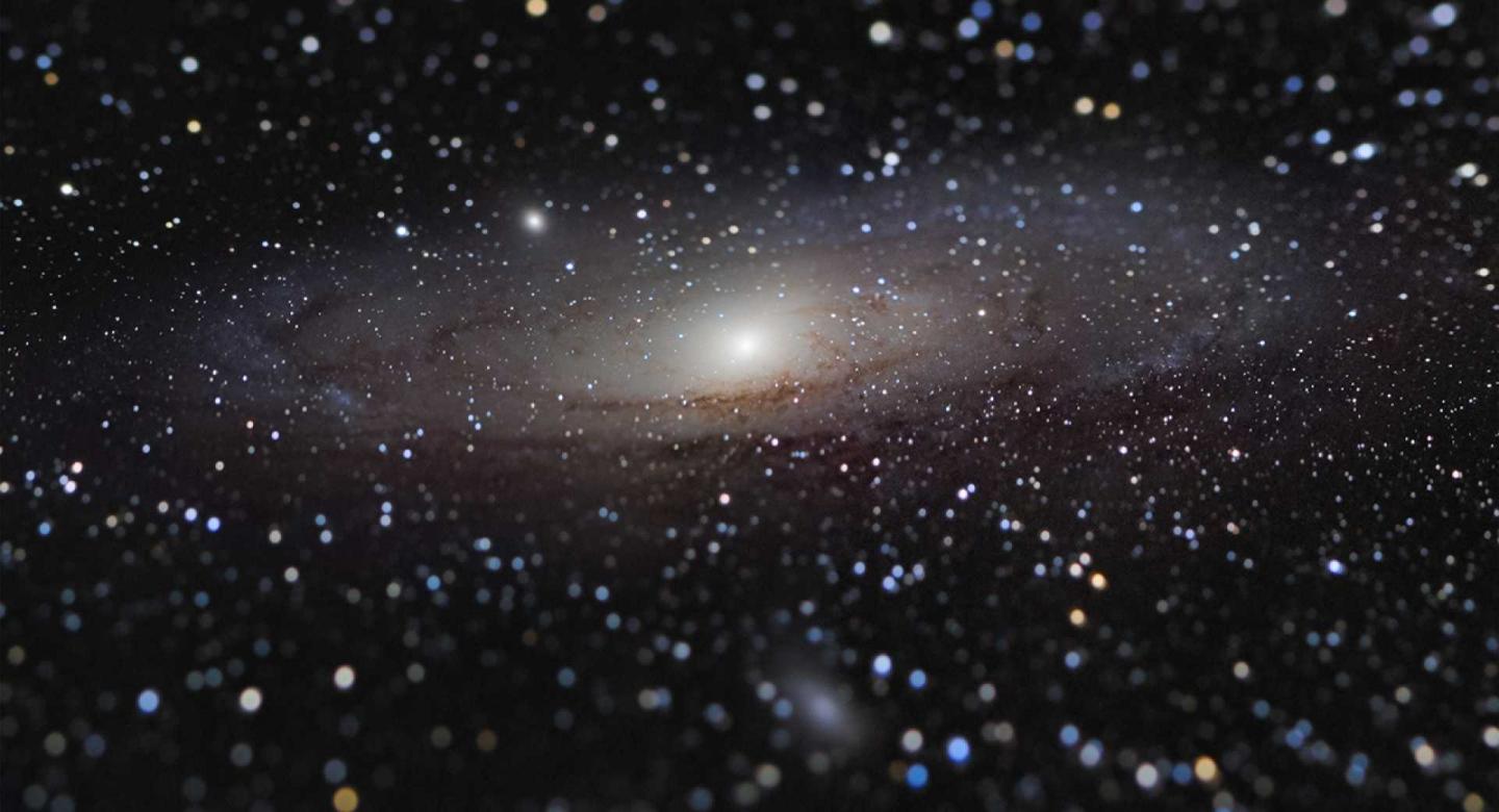 Photo of the Andromeda Galaxy - a dark black sky sprinkled with stars